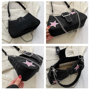 Detail view of black canvas crossbody bag with white stitching and pink star patch