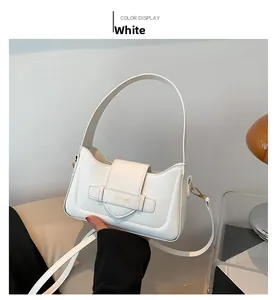 Detail of white PU leather baguette bag with gold buckle and adjustable strap