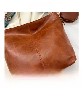Macro shot of vintage brown PU leather bag texture with ethnic embroidered shoulder strap