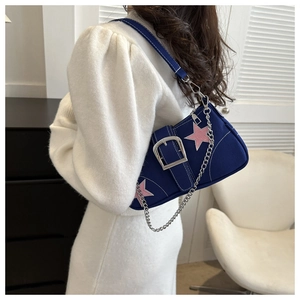 Detail of vintage canvas underarm bag with pink star patch and silver buckle
