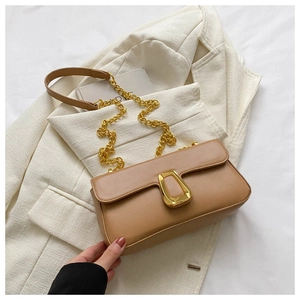 Detail view of camel PU leather bag featuring a gold geometric buckle and chain strap