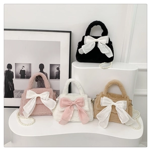 Vue détaillée de sacs en peluche avec nœuds en satin et chaînes de perles élégantes