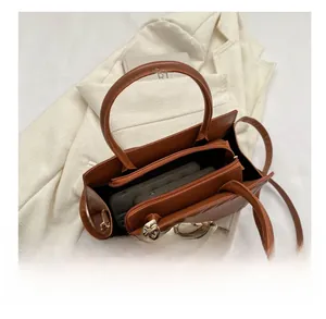 Top view of brown leather tote interior showing large capacity and zipper compartments