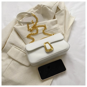 Detail of white leather shoulder bag with gold U-shaped buckle and chunky chain strap