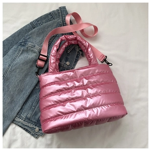 Detailed top view of pink metallic puffer bag with quilted texture and crossbody strap