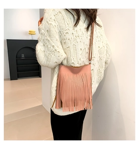 Detail shot of the pink tassel shoulder bag texture and fine leather craftsmanship