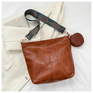 Brown PU leather crossbody bag with ethnic wide strap and small round coin purse charm