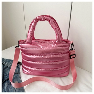 Detailed view of pink quilted tote bag with detachable shoulder strap and puffer texture