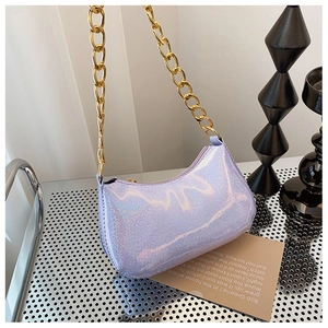 Detailed side view of purple holographic underarm bag with bold gold chain strap