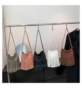 Selection of long tassel shoulder bags in grey, pink, black, white, and brown colors