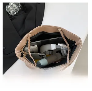 Macro view of beige quilted tote bag interior showing large capacity for essentials