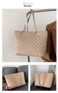 Detail view of khaki quilted tote bag with diamond stitching and woven chain strap