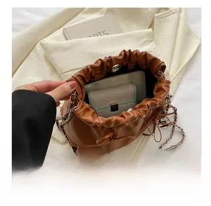 Internal view of brown drawstring bucket bag showing storage capacity with a wallet