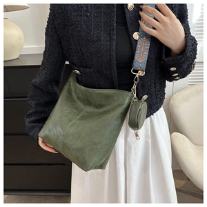 Detail of dark green tote bag with bohemian shoulder strap and round coin purse pouch