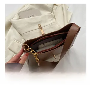 Interior view of brown faux leather shoulder bag showing spacious storage for daily essentials