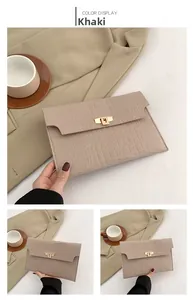Detail of khaki stone pattern felt envelope clutch bag with golden metal twist lock