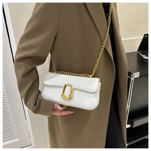 White faux leather crossbody bag featuring a trapezoidal gold clasp and fine chain strap