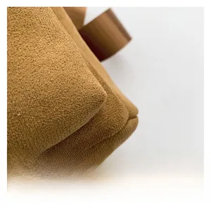Detail of premium caramel suede fabric showing fine stitching and soft texture