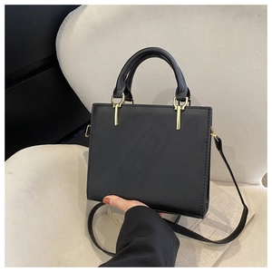 Minimalist black square handbag with stitching and golden buckle detail for women