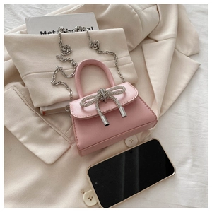 Pink mini crossbody bag featuring a sparkling silver rhinestone bow and chain strap