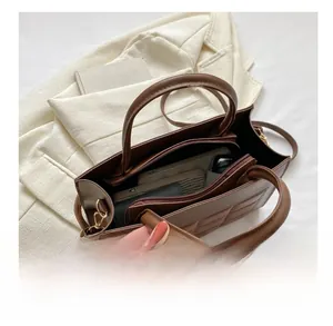 Internal view of a brown vintage tote bag showing large capacity and multi-compartment space