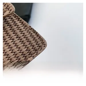 Detailed close-up of woven tan fiber fabric and reinforced stitching on a vintage bag