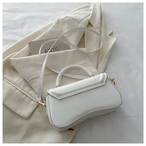 Detail view of the white PU leather handbag featuring stitching and gold-tone metal hardware