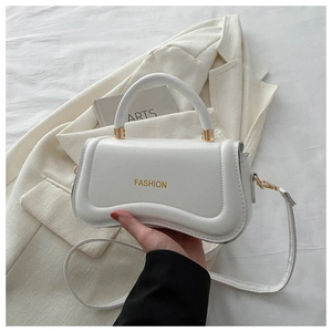 Detail of white PU leather handbag featuring a unique wavy base and gold fashion logo
