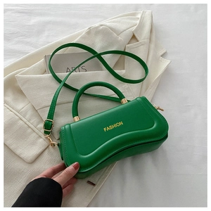Detail of green PU leather handbag with wavy edge, gold hardware, and Fashion logo print