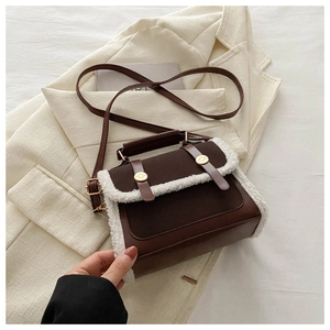 Detail of plush faux fur trim and dark brown leather on the vintage crossbody square bag