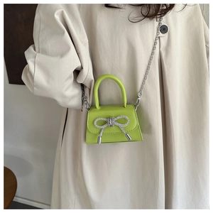 Neon green mini crossbody bag with rhinestone bow and silver chain strap for women