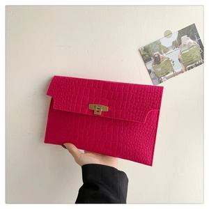 Fuchsia envelope clutch with crocodile texture and golden metal lock detail