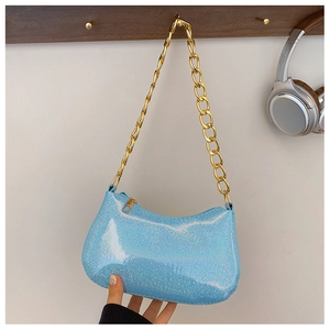 Detail of light blue glitter shoulder bag with chunky gold metal chain strap