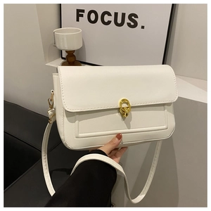 Gros plan d'un sac à bandoulière blanc semi-circulaire avec boucle ronde dorée chic