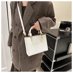 Detail of white leather handbag with gold hardware and contrast stitching for workwear