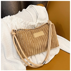 Close-up of caramel corduroy shoulder bag with soft padded strap and retro knot details