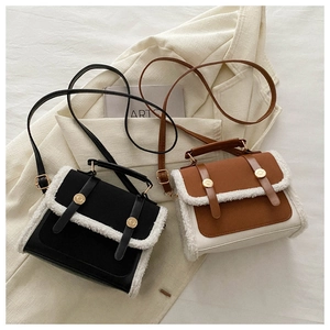 Flat lay of high-quality faux leather bags with plush trim and metal ring buckles