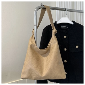 Close-up of retro light coffee tote bag featuring unique knot shoulder strap detail