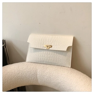 Close-up of cream white rectangle envelope clutch bag with crocodile pattern and gold buckle