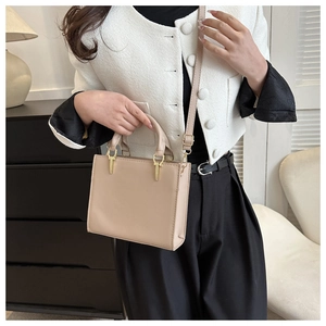 Elegant beige structured faux leather crossbody bag with top handle and gold hardware