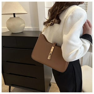 Deep brown leather shoulder bag featuring sleek gold metal buckle and chain strap detail