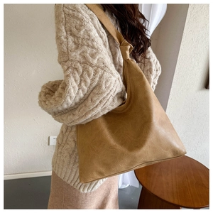 Brown PU leather hobo shoulder bag with knotted strap shown from a back side view