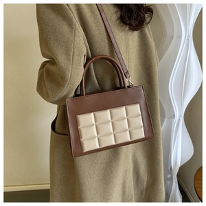 Detail showing the brown and beige patchwork panel of this chic crossbody bag