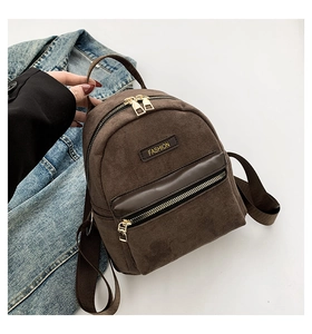 Close-up of brown suede mini backpack with golden zipper and leather details