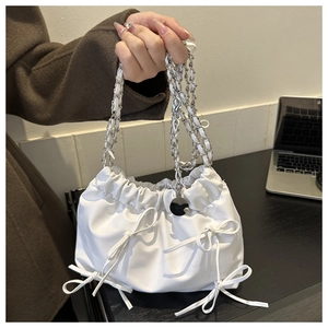 White ruched cloud bucket bag with bow accents and silver chain shoulder strap