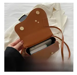 Internal view of the brown saddle bag showing its storage capacity for mobile phones