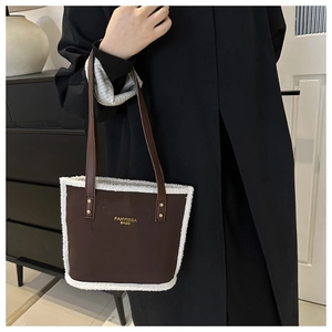 Detail of vintage brown tote bag featuring white faux fur trim and gold FANYISSA logo