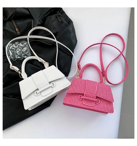 Detailed view of woven texture and trapezoid flap on white and pink handbags