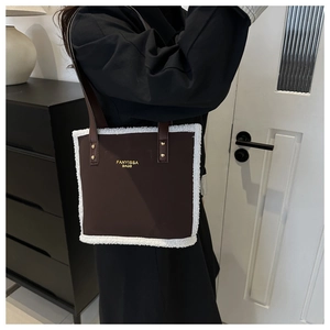 Brown fabric shoulder tote bag with white fleece trim and branded logo for women