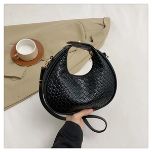 Classic black woven crescent handbag with textured faux leather and adjustable shoulder strap